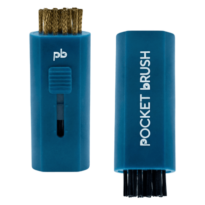 A deep navy blue Pocket Brush golf club brush and groove cleaner with both the brass and nylon bristles exposed lies on a white background.