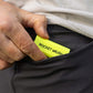 A neon yellow pocket brush is being placed into a pocket